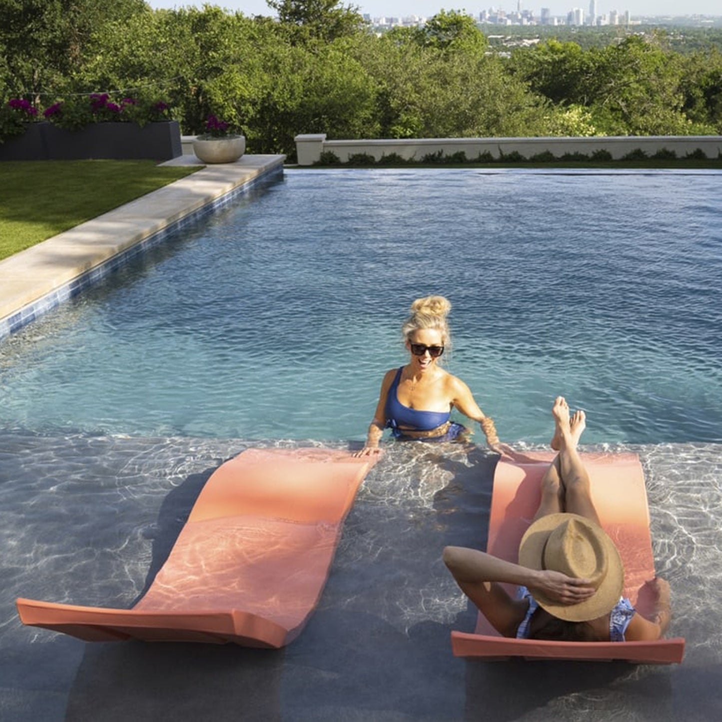 Ledge Lounger signature chaise on a pool ledge